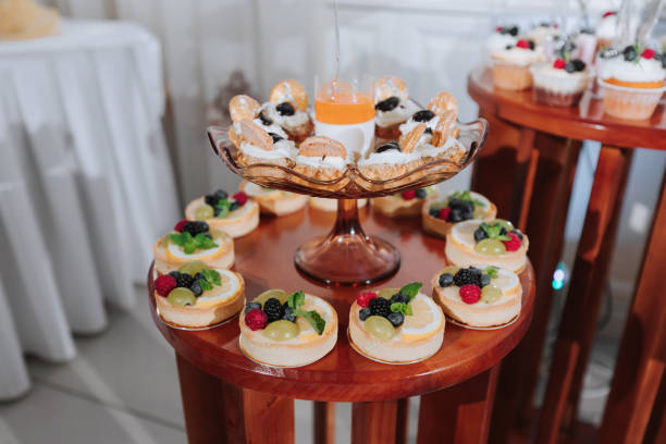 Festive dessert table with sweets. Wedding candy bar, various cakes, chocolates on stands.