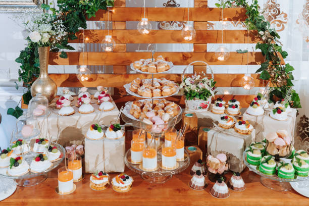 istock Festive dessert table with sweets. Wedding candy bar, various cakes, chocolates on stands. 2072069848