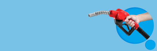 istock Hands holding Fuel nozzle on light blue background 2072093091