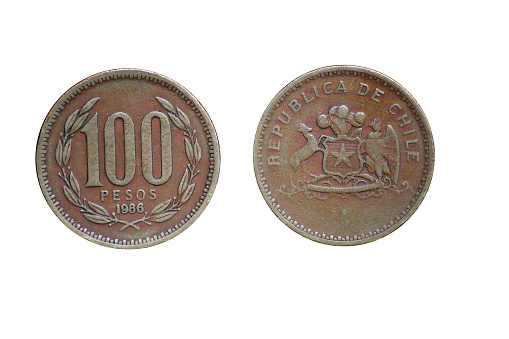 chilean pesos (100 peso coin) front and back from (old weathered damaged worn coin from 1986) republica de chile (money, currency, economy, savings, salary, business) isolated on white background