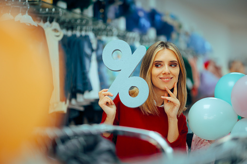 Person enjoying clearance offers in a clothing boutique