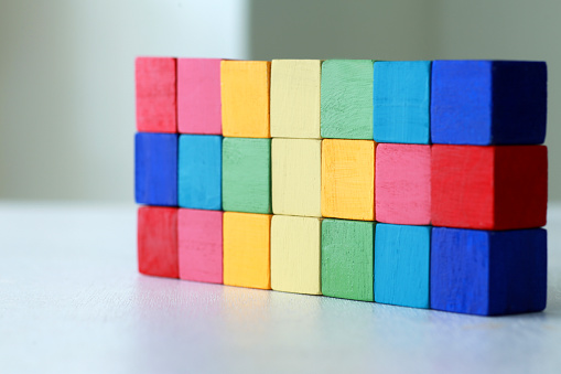 Business design concept. Cube wooden block toy stacked without graphics. Blank space.
