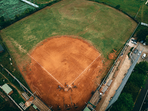 Baseball field with fence surrounded by lush greenery at the Eola Community Center in Aurora, Illinois