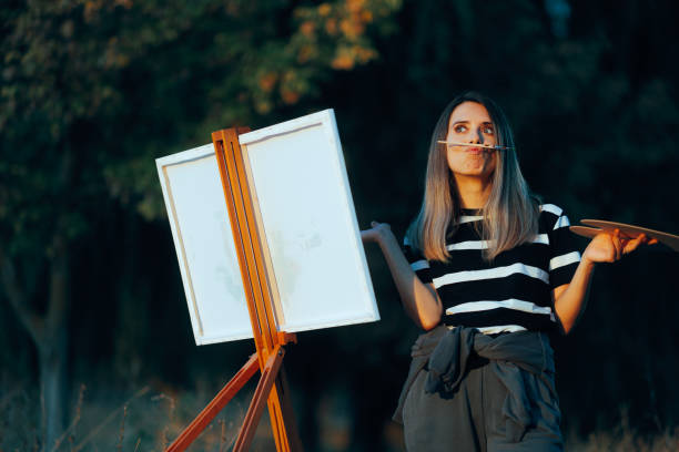 istock Funny Artist Balancing a Brush on her Lips Procrastinating 2072305374
