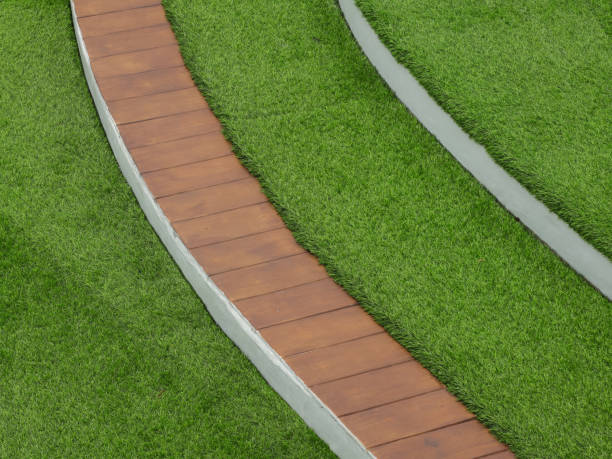 istock Grass field background and a natural wooden plank. 2072333286