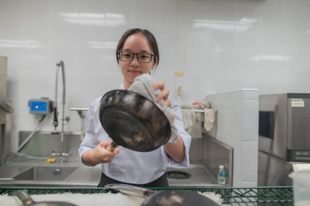 asian female apprentice kitchen clean cook pan - hygiene food chef trainee fotografías e imágenes de stock