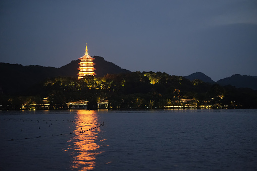 Leifeng pagoda and reflection in west lake at night, in Hangzhou, Zhejiang, China