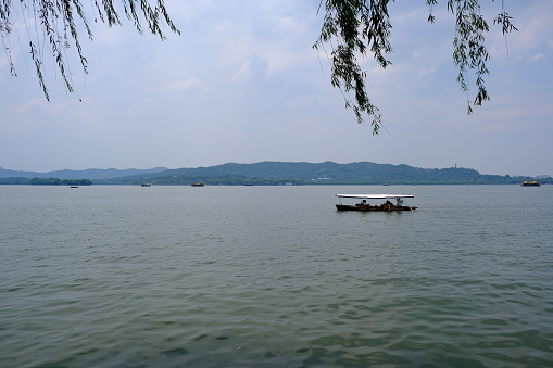 west lake with tourist on cruise tour boat. In Hangzhou, Zhejiang, China