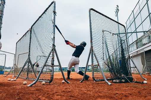 Baseball player, bat and homerun with sky and baseball for sports, game or contest outdoor in summer. Man, sport and hit in sunshine at stadium, arena or field in competition, match or training