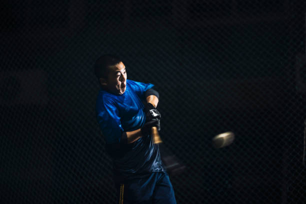 istock During night-time self-practice, baseball players persistently practice their hitting skills to improve their overall proficiency in the sport. 2072351610