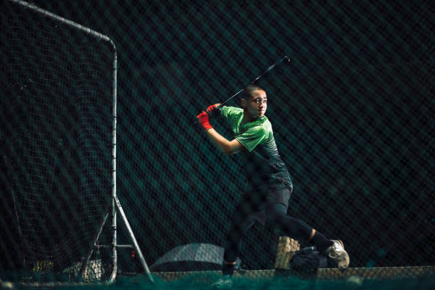 istock During night-time self-practice, baseball players persistently practice their hitting skills to improve their overall proficiency in the sport. 2072352376