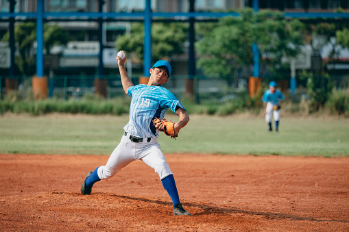 Porfessional baseball player with bat taking a swing on grand arena. Ballplayer on stadium in action