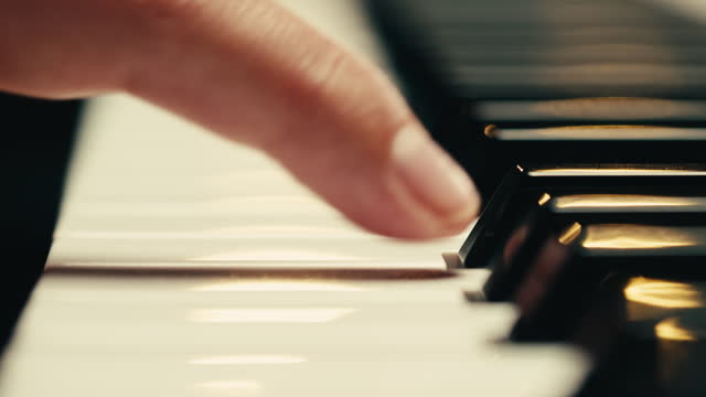 Young woman pianist playing classical music on a grand piano close-up. Classic music concert or repetition