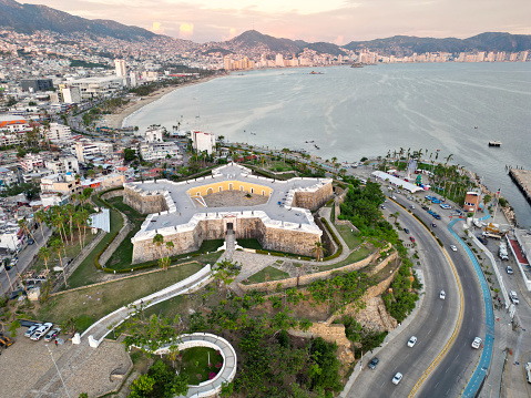 Overhead drone shot capturing the imposing Fuerte de San Diego, a landmark fortress overlooking the bay of Acapulco