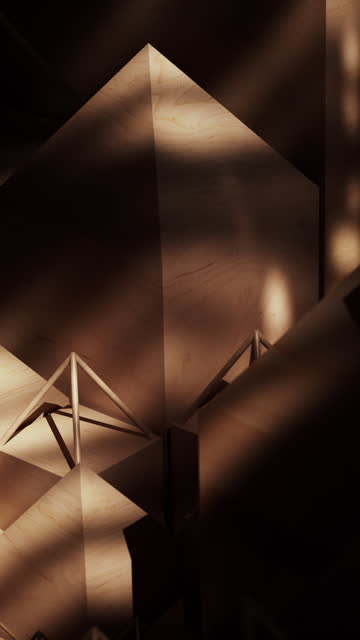 An abstract backdrop featuring sunlit wooden pyramids.