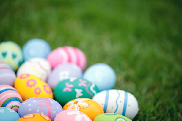 Collection of colorful easter eggs on green grass to celebrate Easter or spring.