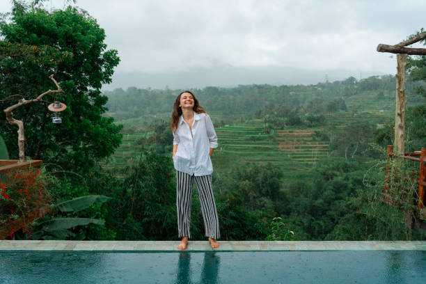 istock Woman  resting on villa on Bali surrounded by rice terraces 2072495862