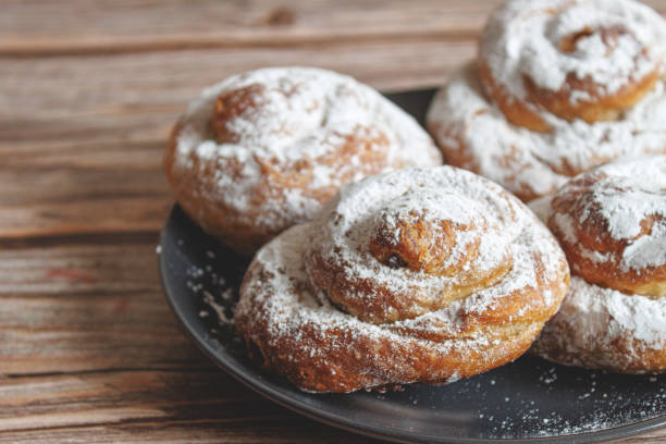 istock Several Ensaimada on a plate, on a brown table, typical Spanish sweet from the Balearic Islands 2072498513