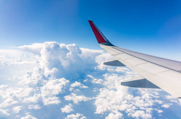 istock View from the airplane window at a beautiful cloudy sky and the airplane wing 2072543391