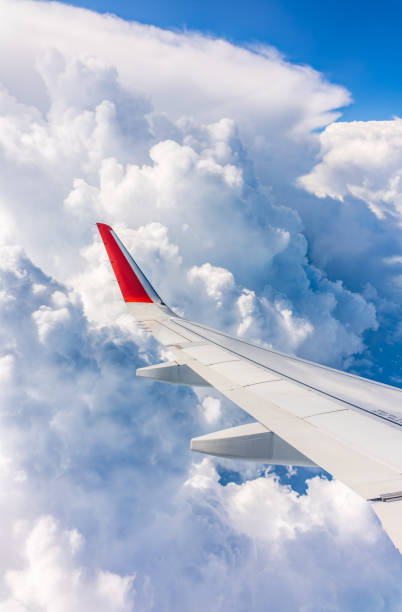 istock View from the airplane window at a beautiful cloudy sky and the airplane wing 2072543396