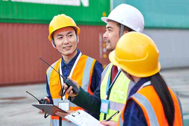 istock Three Asian Coworker Discussing at Commercial Dock 2072567914