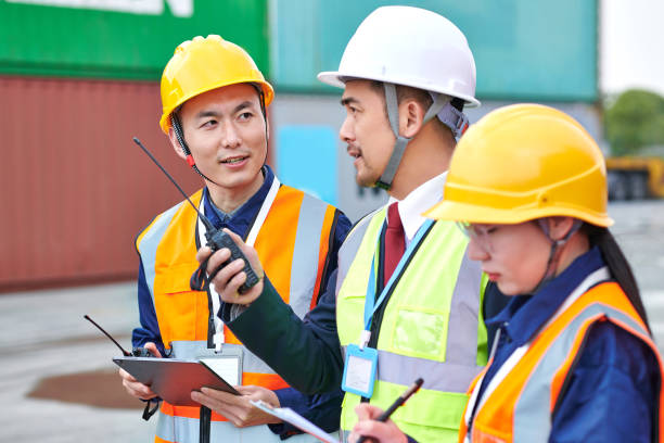 istock Three Asian Coworker Discussing at Commercial Dock 2072569483