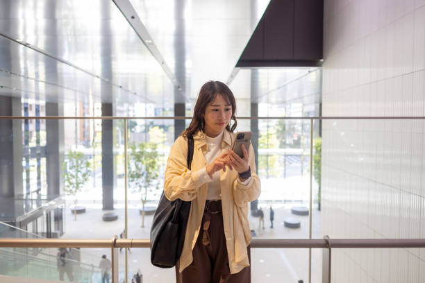 istock Business woman using smart phone in building 2072582400