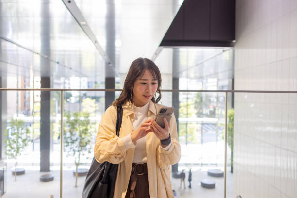 istock Business woman using smart phone in building 2072583955