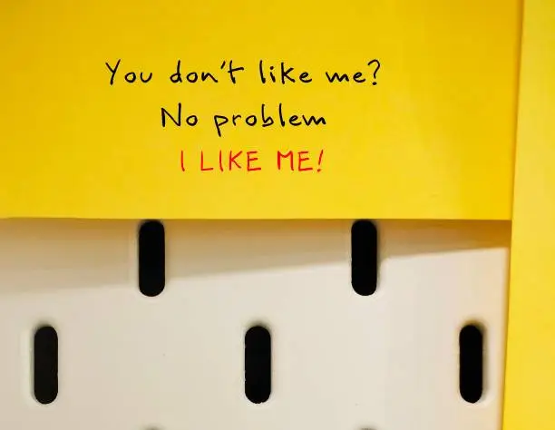 Yellow note on wall with handwritten text YOU DON'T LIKE ME? NO PROBLEM - I LIKE ME  - Self-love concept - affirmation to stop caring what other thinks, work on self-respect and self-worth,  learn how to put yourself first