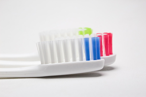 close up of several toothbrushes on a white background