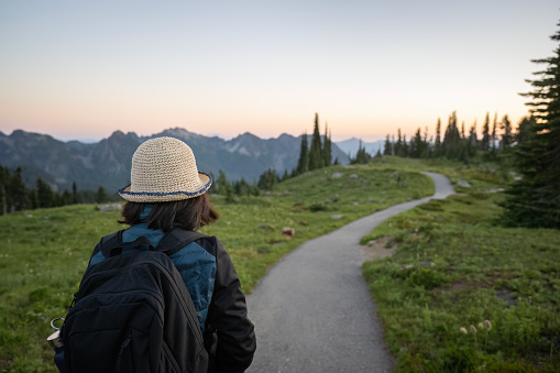 Woman walking in Paradise at sunset. Mount Rainier National Park. Washington State.