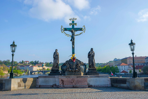 Statuary of the Holy Crucifix and Calvary on Charles Bridge, in Prague, Czech Republic, in sunny day