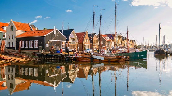 Urk Netherlands October 2020, Old historical harbor on a sunny day, Small town of Urk village with the beautiful colorful lighthouse at the harbor by the lake Ijsselmeer Netherlands Flevoland Europe