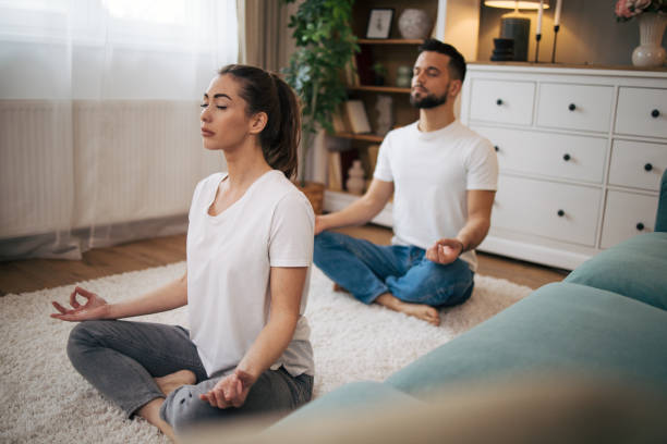 istock Adult couple practicing yoga at home. 2072656836