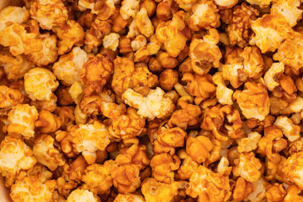 istock sweet popcorn in icing sugar, snacks, yellow background 2072659981