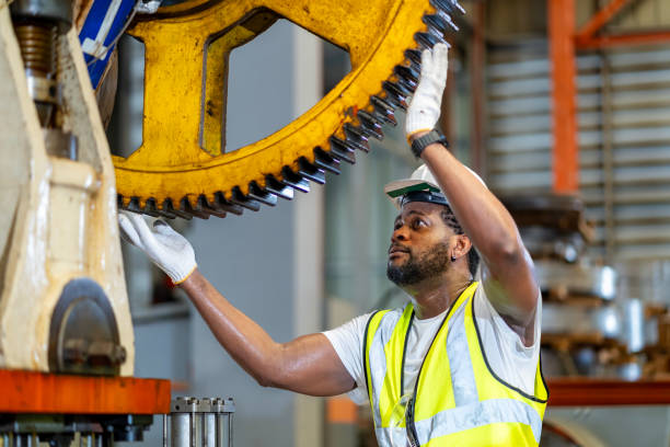 istock African American mechanic worker is checking the gear for hydraulic machine inside metal steel manufacturing factory for maintenance and inspection 2072664112
