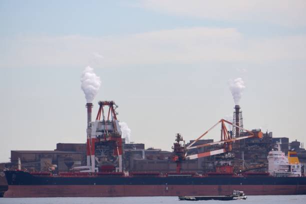 [Factory scene] A factory spewing smoke from its chimney.