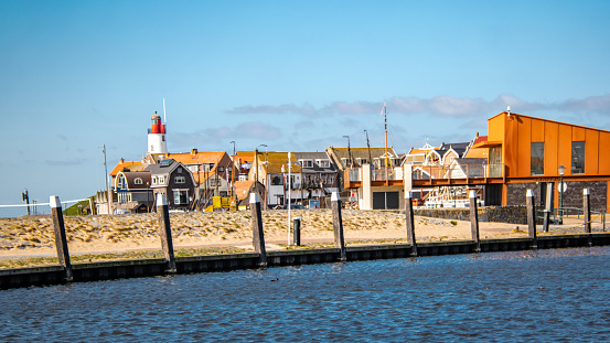 Urk Netherlands Small town of Urk village with the beautiful colorful lighthouse at the harbor by the lake Ijsselmeer