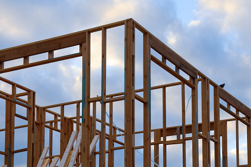 house under construction with building frame against sky