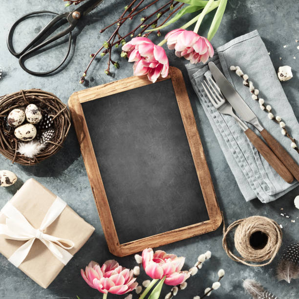 istock vintage chalk board, spring flowers and cutlery on dark blue background 2072691610