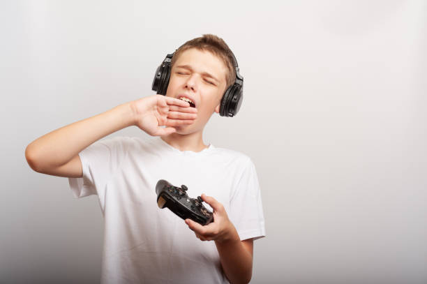 Happy child listening playlist music with headphones outdoor in city park - Focus on right eye