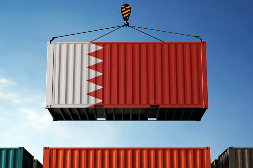 Bahrain trade cargo container hanging against clouds background