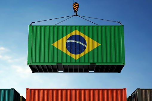 Brazil trade cargo container hanging against clouds background