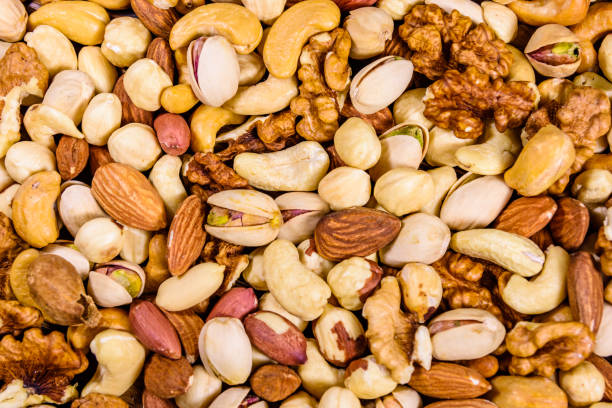 background of the various nuts (almond, cashew, hazelnut, pistachio, walnut). vegetarian meal. healthy eating concept - peanut legume textured effect fat zdjęcia i obrazy z banku zdjęć