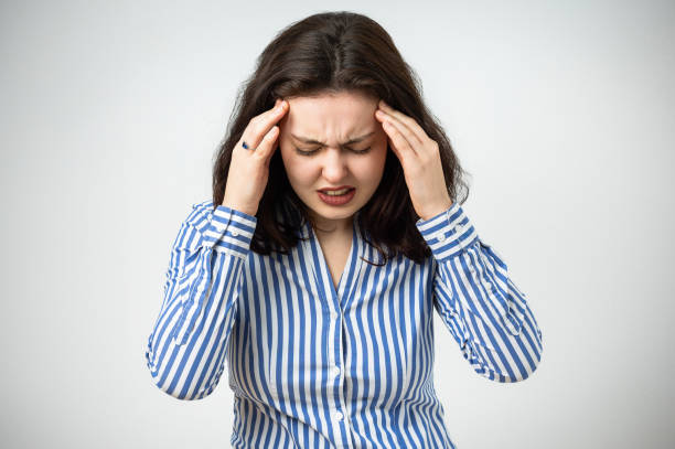 istock Young beautiful woman has headache isolated studio portrait 2072722837