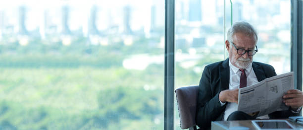 istock Business partner executive smart man sitting and reading newspaper in restaurant. 2072727778