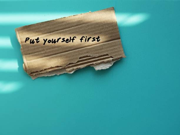 istock Card box paper on blue copy space background with handwriting text PUT YOURSELF FIRST - Prioritize your needs are important as everyone elses, treat yourself with kindness and set personal boundaries 2072759928