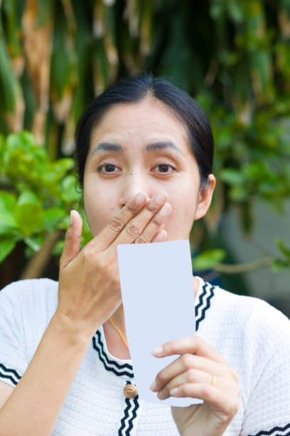 istock Surprised thai woman holding winning lottery ticket 2072766137