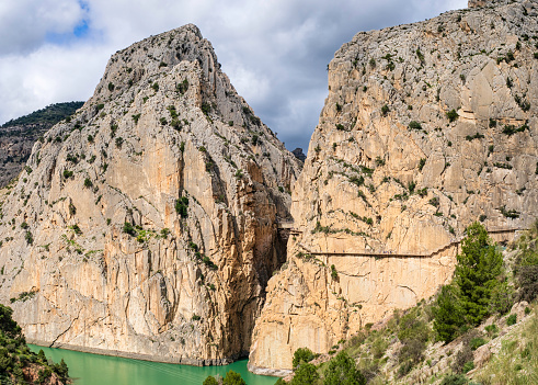 Amazing views along El Caminito del Rey, a long walkway hanging over 100 metres up on a sheer cliff face in a narrow gorge that runs through cliffs, canyons, and a large valley (5 shots stitched)