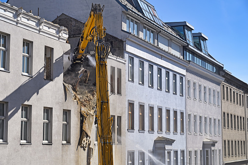 A bulldozer is demolishing an old building in Vienna Austria